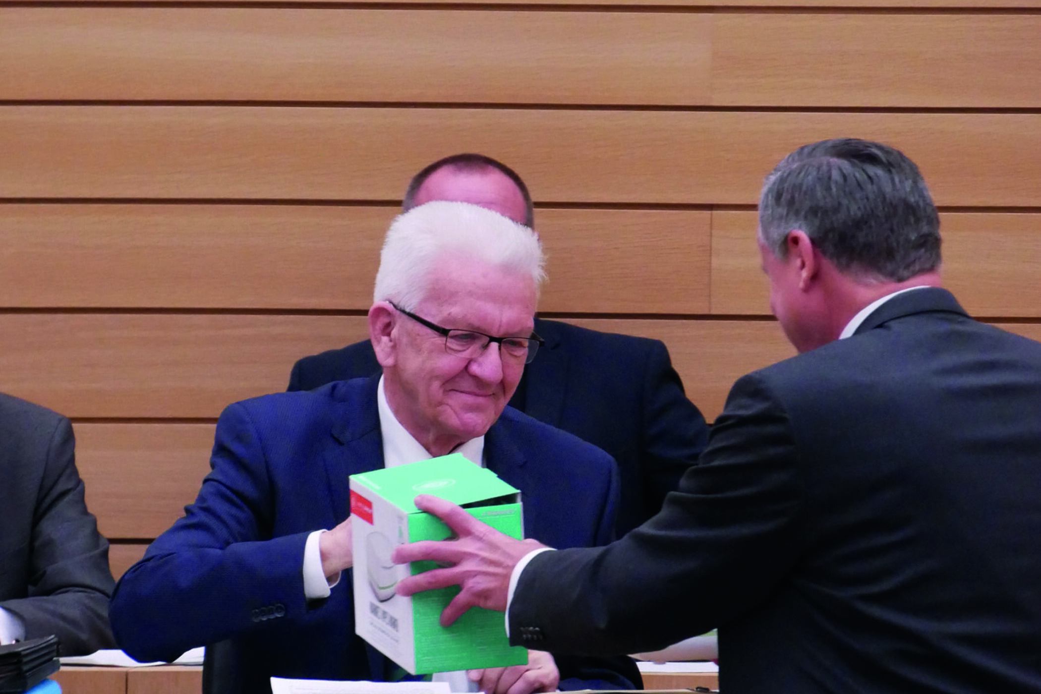 Der FDP-Fraktionschef Hans-Ulrich Rülke übergibt Winfried Kretschmann einen Waschlappen-Wärmer