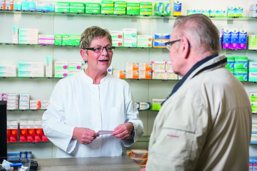 Eine Apothekerin berät in einer Apotheke in Flensburg einen Kunden