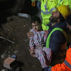 Dolmetscher Baris hält das sechsjährige Mädchen im Arm, dass die Katastrophenhelfer aus Deutschland nach 72 Stunden unter Trümmern mit seiner Mutter retten konnte.