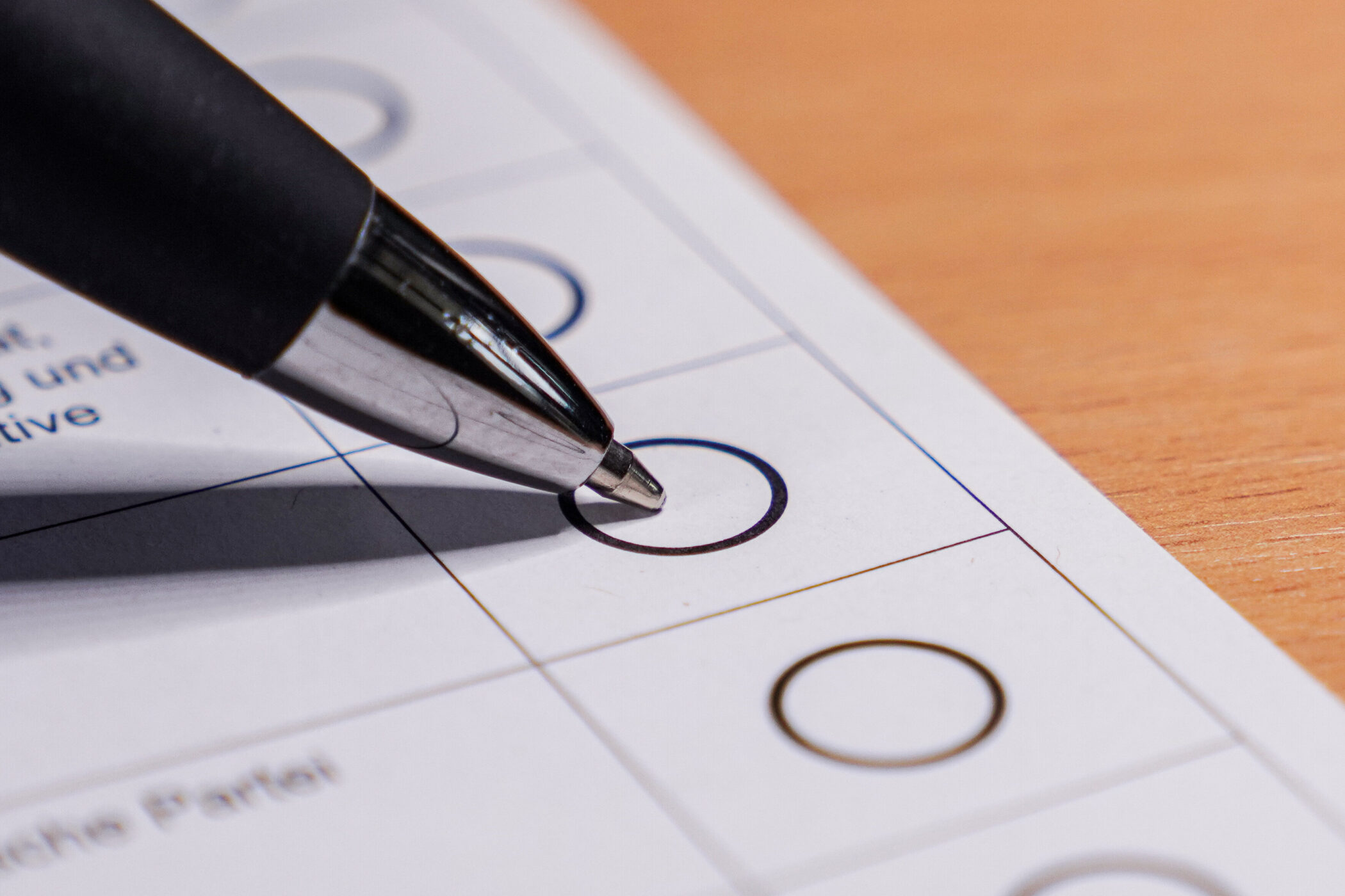 Kugelschreiber über einem Kreis auf einem Papier mit mehreren Kreisen.