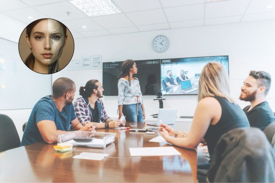 Sechs Personen in einem Konferenzraum, eine Frau zeigt auf einen Bildschirm.