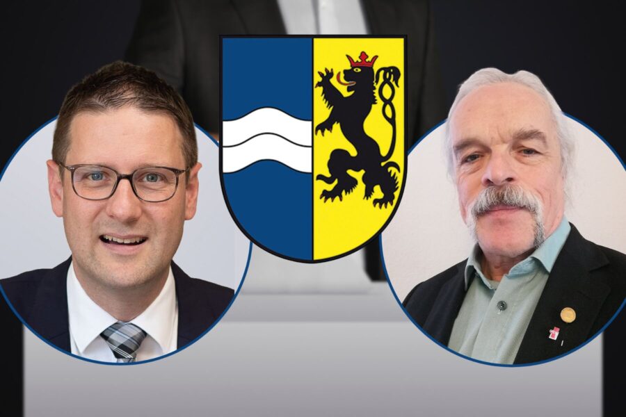Zwei Männer in Anzügen, dazwischen ein Wappen mit Löwe und Wellen.