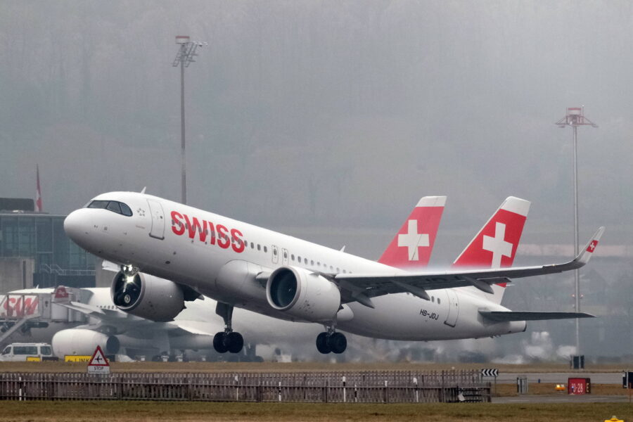 Flugzeug der Swiss hebt vom Flughafen ab, im Hintergrund weitere Flugzeuge.