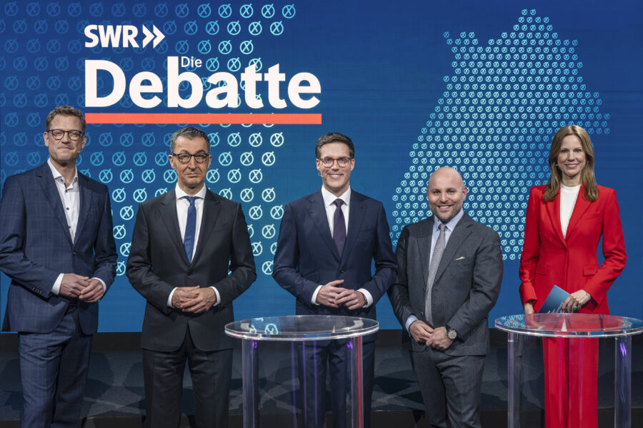 Fünf Personen stehen auf einer Bühne vor der Aufschrift "SWR Die Debatte".