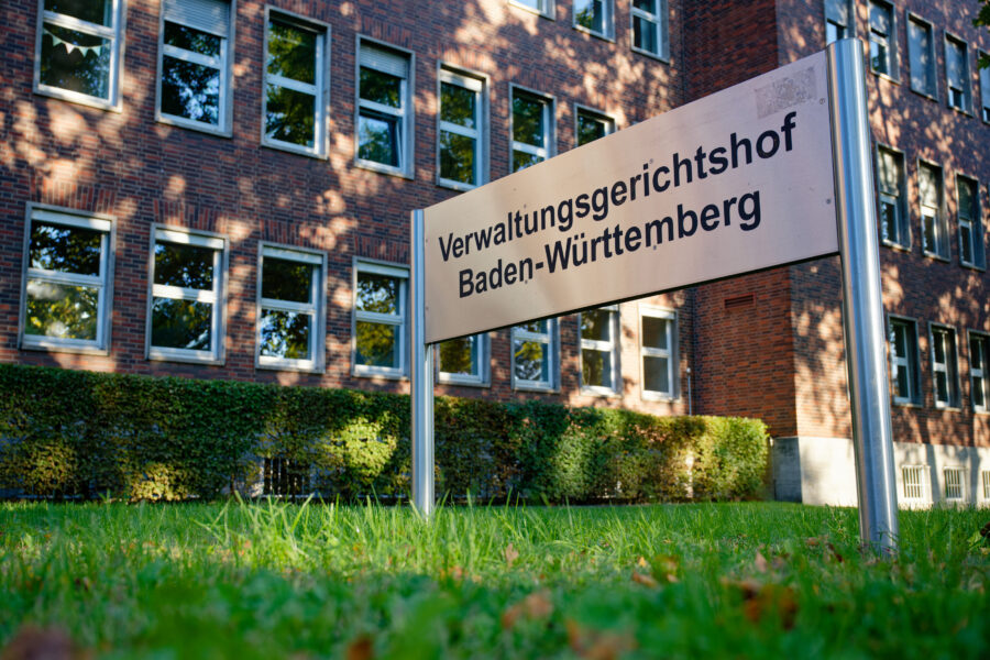 Schild mit Aufschrift "Verwaltungsgerichtshof Baden-Württemberg" vor Backsteingebäude.