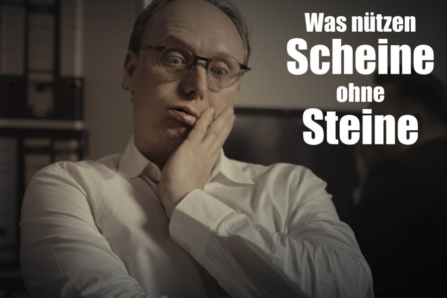 Mann im weißen Hemd, Hand am Gesicht, steht vor Aktenordnern. Text: „Was nützen Scheine...“