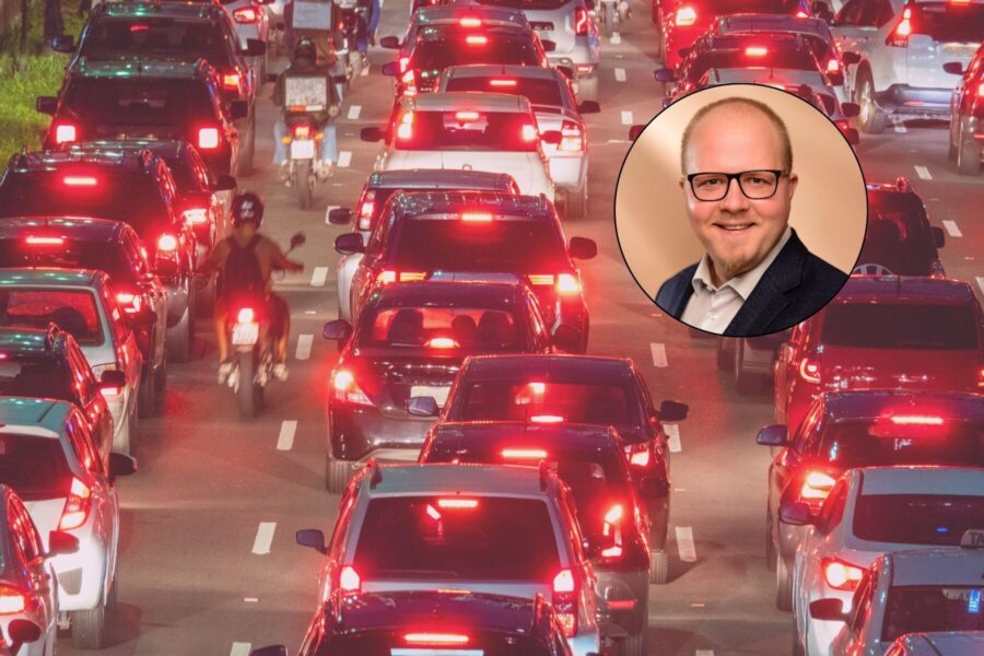 Verkehrsstau mit vielen Autos; Einblendung eines Mannes mit Brille und Bart.