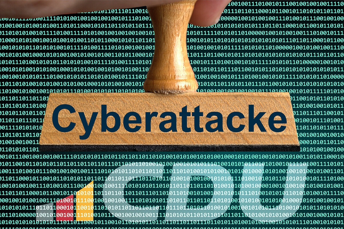 Stempel mit "Cyberattacke" vor Binärcode-Hintergrund.